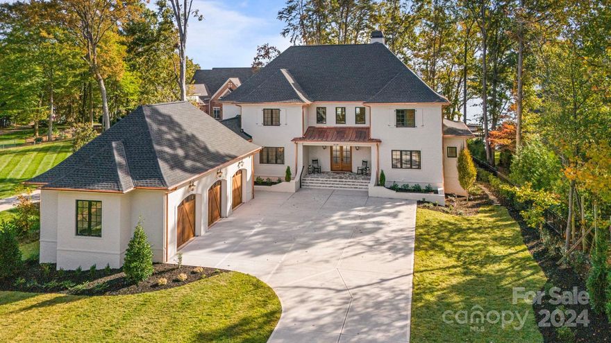 New construction waterfront custom home, boasting premium finishes inside and out. Two large telescoping doors welcome you as you gaze out to the magnificent Lake Norman views. Two-story family room accented by a stone fireplace with a cast stone mantle. The expansive kitchen features exquisite Kith cabinetry, Thermador appliances, a scullery w/additional oven and a wine refrigerator. Main-level primary suite, plus a 2nd primary on the upper-level.  The finished walk-out includes a game room, wet bar, fitness room, media room, and ample storage. As you step outside to the backyard, you'll find a meticulously landscaped haven complete with a saltwater spa and pool surrounded by an extensive patio, providing a tranquil setting to enjoy the main channel and sunset views. A pathway leads to your private covered dock w/lift. Finished three-car garage with cedar garage doors and epoxy floors. A masterpiece of custom craftsmanship, designed for those who appreciate the finer things in life.