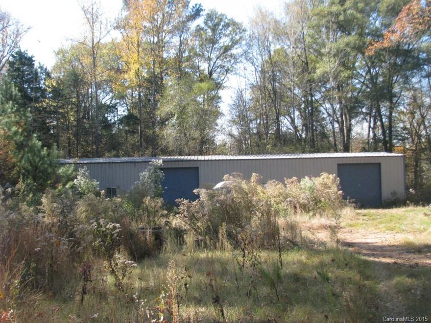 Large Metal Building on Heavy Duty Slab with 2 Bay Doors.  Has large capacity well.  Located near back of heavily wooded 5 Acre lot for privacy.  Only 3 miles from Hwy 901 for quick access to I-77.