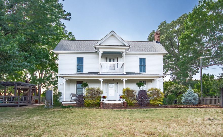 Step into history with this stunning 1898 farmhouse situated on 1.7 acres in beautiful Rowan County. Meticulously cared for over the years, this one-of-a-kind property offers timeless character, modern updates, and endless possibilities. The home has recently been painted inside and out, adding a fresh touch while preserving its historic charm. The main home features gorgeous hardwood floors throughout, multiple fireplaces, and charming historic details at every turn. The kitchen has been thoughtfully updated with new appliances, cabinetry, sink, and hood while maintaining the home's original character. Portions of the plaster walls have been removed to showcase the original shiplap. Three of the fireplaces on the main level are functioning gas fireplaces, and cedar-lined closets can be found throughout the home. A separate 2nd living quarters provides incredible flexibility for multi-generational living, guest space, or potential rental income. The impressive two-story outbuilding offers even more opportunity and could serve as a home office, workshop, potential additional living space, or a unique treehouse retreat. Outdoor living offers a side patio area featuring a raised herb garden, outdoor fireplace, and a deck with pergola, the perfect place to relax and enjoy the peaceful surroundings. The property is also perfectly suited for those dreaming of homesteading with a fenced chicken coop and rainwater collection barrels already in place. & lots of garden space. This truly special property blends historic beauty, functionality, and endless potential in a peaceful country setting.