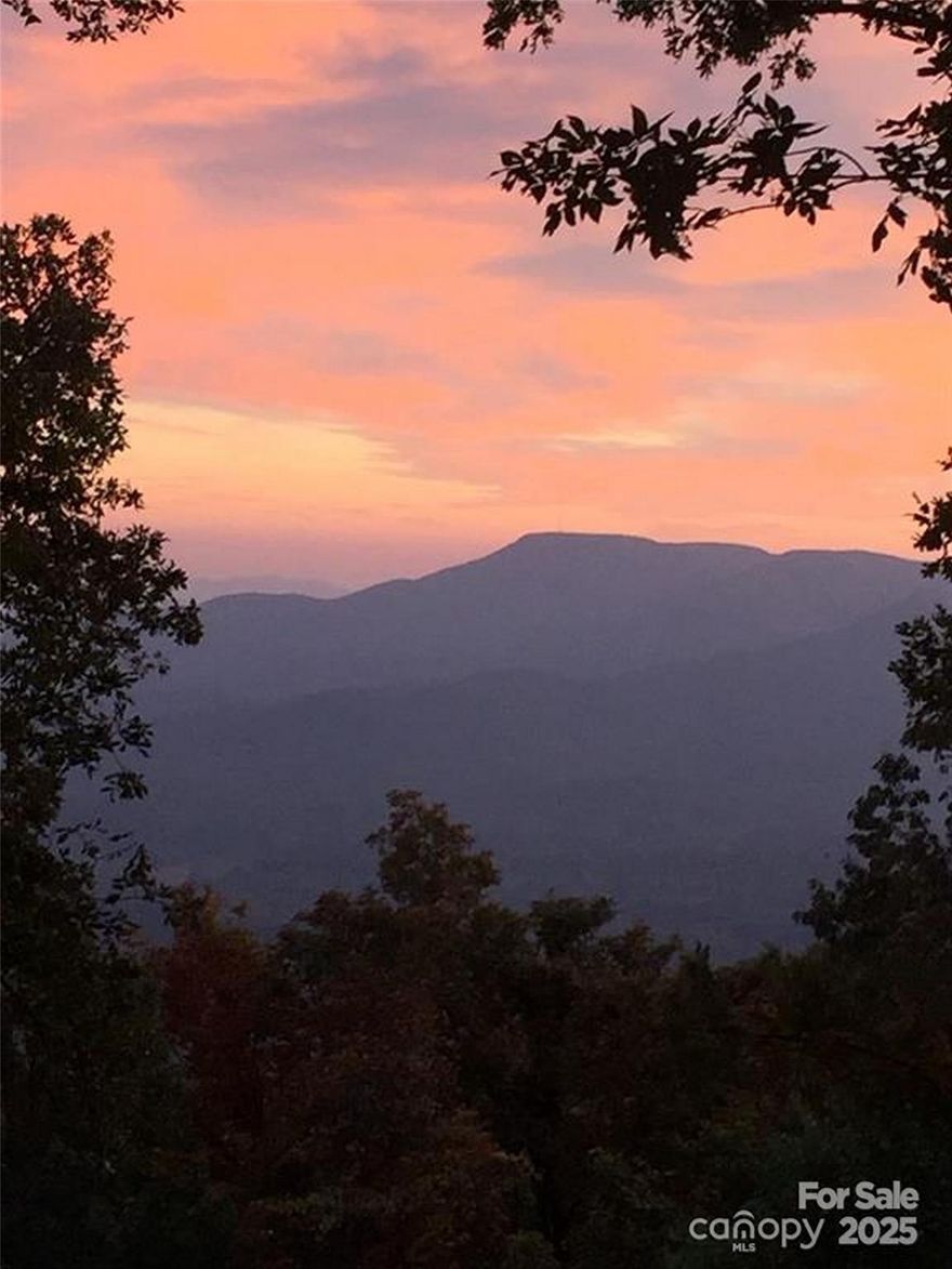 Gorgeous southwest facing lot on White Oak Mountain with year round breathtaking views. Enjoy the sunset every evening. Build your dream home and join this established mountaintop community with 3 stocked ponds, pavilion picnic area, paved roads and community well. Suitable for vacation or year round living. Easy access to Asheville, Spartanburg and Greenville. Originally two lots, there is paved access to both top and bottom of the property.