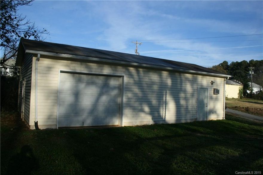 Garage type building on over one acre, in Stanley, garage space with several other rooms, half bath. baseboard heat.