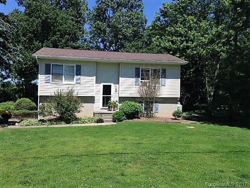 Great 2 Bedroom/ 1 Bath one level home in Mills River. Single car garage in basement. Nice level lot. Electric baseboard heat with propane backup. Shared well. Fenced in back yard. Home is getting a facelift. Great area, convenient to everything. Wonderful starter home or investment home. Continually rented for 9 years. Seller is providing a $1,500 flooring allowance.