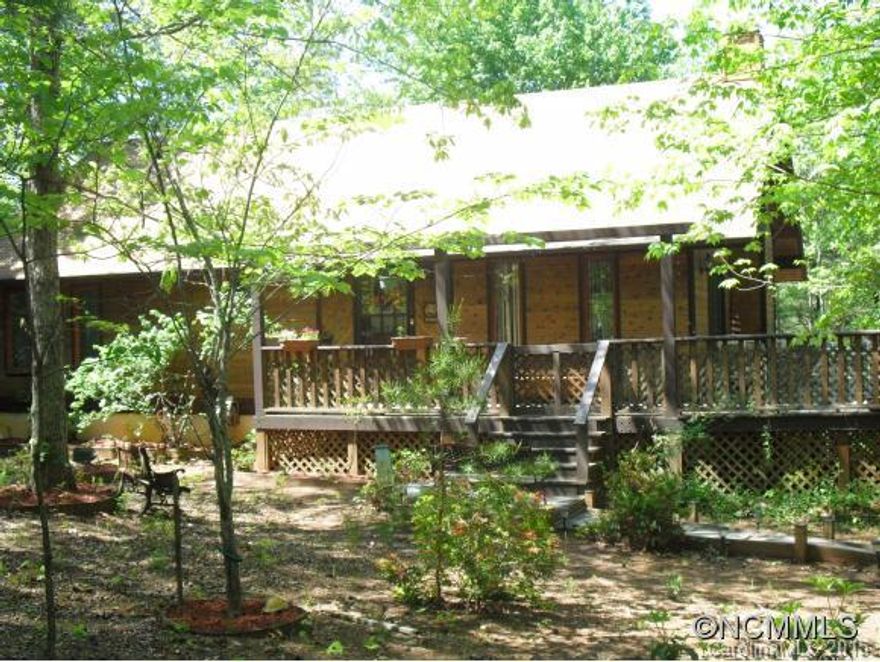 A lovely cedar log home in Shumont Estates at Rumbling Bald Resort. Two bedrooms, two baths and large loft with third sleeping area.  Vaulted cedar ceilings and cedar fireplace surround adds ambiance to this great room.  Kitchen has new granite counters, like new oak cabinets and tile floor. Master bedroom opens on to sun room. Large wrap around decks. Large basement/garage area provides multiple car parking, workbench and storage. Estate sale.