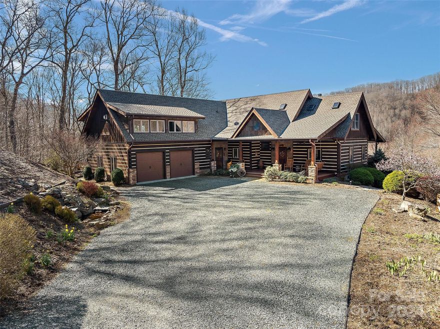 The perfect retreat, full-time residence, or investment property w/ long-range Blue Ridge & Grandfather Mountain views, resting on 6.8+ acres of wooded privacy. This FURNISHED 3BR 3.5BA lodge offers all main amenities on the walk-in level, w/ open-concept floorplan & ample outdoor living space. Short-term rentals allowed= vacation rental potential! A spacious great room w/ vaulted ceilings & stone fireplace opens to dining area & kitchen w/ high-end appliances & granite counters. Enjoy the views from the large wrap-around deck & stone patio w/ firepit. Main level features 2 suites; the primary suite shares access to sunroom/study area & features walk-in closet, large shower, & separate soaking tub. On the second level over the main part of the home, find a loft/sitting area, bedroom, bonus room or office, & full bath. A separately accessed 2nd level provides a 2nd large living room/game room w/ stone fireplace, full wet bar w/ beverage/wine cooler, & half bath. Furnished w/ Exceptions.