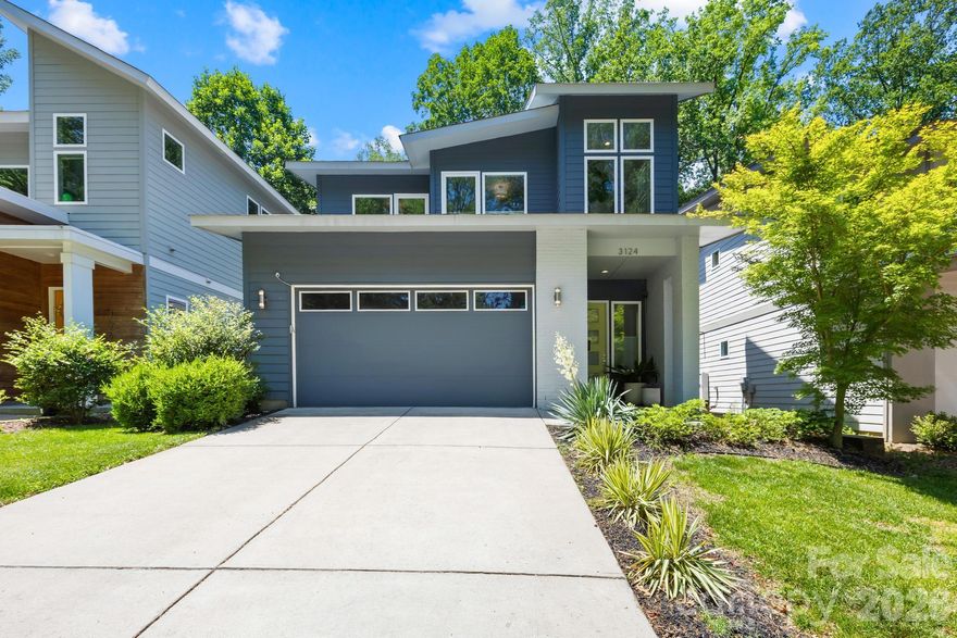 Striking modern home located in the heart of Commonwealth Park offering the perfect blend of urban convenience, functional living, and private outdoor space. Built in 2019, this light-filled residence features an open-concept layout, soaring ceilings, oversized windows, and designer finishes throughout.

The chef’s kitchen anchors the main living area with a massive island, walk-in pantry, abundant cabinetry, and seamless flow into the dining and living spaces - ideal for entertaining or everyday living. Fresh interior paint and thoughtful upgrades make the home truly move-in ready.
  Upstairs, the spacious primary suite offers a true retreat with generous closet space and a spa-inspired bath, while additional bedrooms provide flexibility for guests, office space and more.

Step outside to a fully fenced backyard designed for relaxing and entertaining, complete with extensive custom landscaping and hardscaping, covered patio, retractable awning, and multiple gathering spaces rarely found in newer construction nearby.
Rare for the area, the home also features a full two-car garage and additional driveway parking, providing convenience and storage that many nearby homes simply do not offer.

Located just minutes from the restaurants, breweries, coffee shops, and nightlife of NoDa, Plaza Midwood, and Uptown Charlotte, this home delivers modern living in one of Charlotte’s most sought-after neighborhoods.