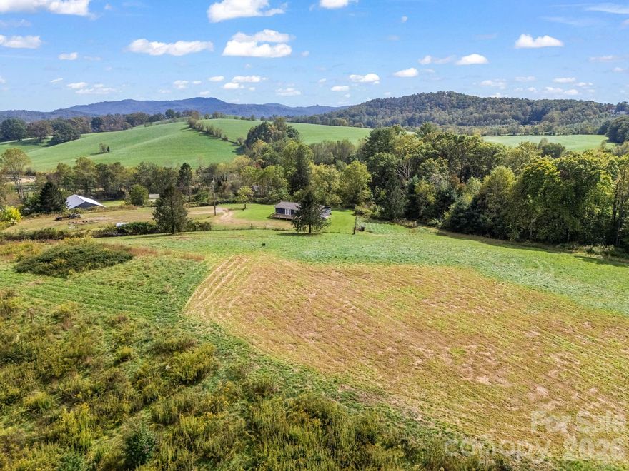 Mills River. 49.9 acres ideally situated and convenient to Asheville, Hendersonville, and Brevard. Only minutes away from the national forest, breweries, shopping and dining. Whether you enjoy hiking, horseback riding, mountain, biking, or camping you will love this peaceful location.
Live in the existing home or build your dream home. Three bedroom two bath home is move-in ready with new paint inside and out, newer flooring, and decks. It has a three bay workshop/barn. Grading has been completed for building another home and barn. You will be impressed with the incredible views in every direction.
This is a hunting and fishing paradise with abundant wildlife in the lush meadows and woods. Boylston Creek (which runs through the middle of the lower fields) is great for fishing and swimming.
Most of the property has already been fenced. This farm has Farm status and therefore lower taxes. Bring your horses, cattle and other livestock. Make your own hay and be self-sustaining.