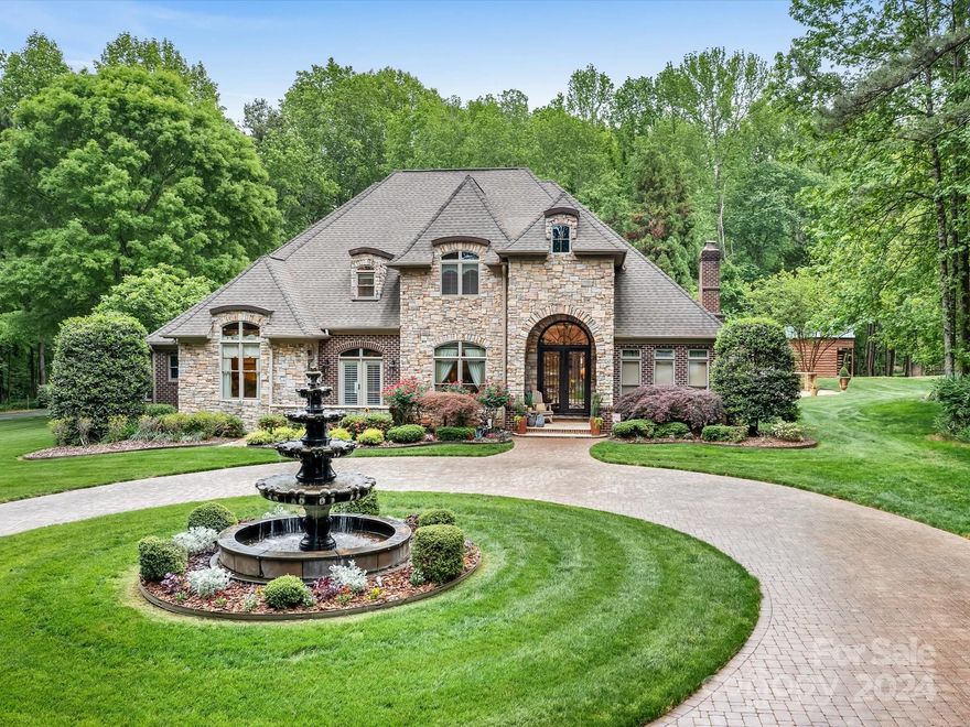 UNRESTRICTED LUXURY ESTATE ON 16+ ACRES. Beyond the gated entrance lies a breathtaking custom equestrian estate where every detail exudes sophistication and charm. Indulge in the heated pool, hot tub, outdoor kitchen and fireplace-perfect for entertaining or tranquil moments of reprieve. Indoors the main floor boasts a media room, primary suite with private patio, soaring ceilings, wet bar, wood burning stone fireplace and an attached 2 car garage.  Additionally a separate 3 car garage with living space above, impresses with its tailored designer finishes and could be used for guests or income. For equine enthusiasts the 4 stall barn, tack room, washbay, turn-out paddock and hayloft are a dream come true. Ride the wooded trails on horseback or ATV, there is something for everyone here. Impeccably maintained and crafted for the most discerning buyer, this estate is a true gem waiting to be discovered. Don’t miss the rare opportunity to own this unrestricted property in Mooresville.