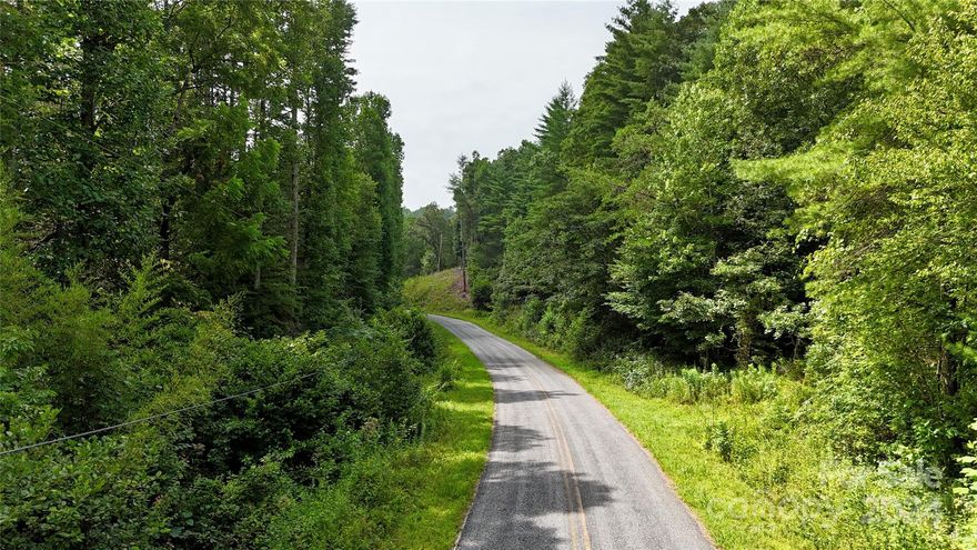 Located in Cherokee County near Murphy, North Carolina, this unrestricted tract combines privacy, natural features, and recreational opportunities. Situated at the end of a paved road, the property offers easy access while maintaining seclusion. With acreage on both sides of the road, there is potential for multiple homesites, a subdivision, or simply preserving the land for recreation.

Directly adjoining U.S. Forest Service land, the tract provides immediate access to public acreage for hunting, hiking, and exploration. Just beyond the forest boundary lies Hiwassee Lake, a reservoir formed by the Hiwassee Dam. The lake offers fishing, kayaking, and boating, with a public boat ramp only 1.5 miles away. A forestry road already extends several hundred yards into the property, leading to a potential building site with mountain views. Additional build locations allow for flexibility in future use.

The land features mature hardwoods, pine timber, and a small creek, enhancing both ecological diversity and recreational value. A spring well exists on site, along with an old farmhouse of no contributory value. Conveniently located, the tract is 15 minutes from Murphy, 20 minutes from Andrews, 30 minutes from Hayesville, and about 40 minutes from Blairsville and Blue Ridge, Georgia.