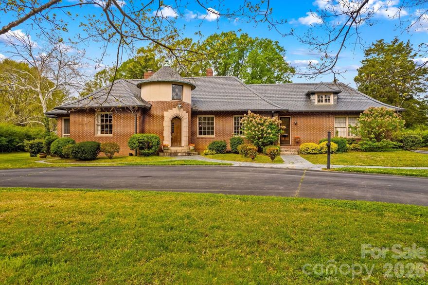 This is the one you’ve always admired—driving by and wondering if it would ever come on the market. Now is your opportunity.

Ideally located near the Salisbury Country Club, hospital, and shopping, this stately brick home blends timeless character with modern comfort. A classic slate roof, circular drive, and two-car garage create an unforgettable first impression, while the striking 12-foot diameter circular foyer sets the tone the moment you step inside.

Rich in history yet thoughtfully designed for today’s lifestyle, the home features tall ceilings and elegant spaces perfect for showcasing art or tapestries. The formal living room is both grand and inviting, with a fireplace and seamless flow into a spacious dining room—ideal for entertaining.

The heart of the home opens beautifully from the breakfast area into an expansive kitchen and family room. The chef’s kitchen offers granite countertops, abundant cabinetry, a bar area, pantry, and side buffet—perfect for gatherings both large and small. The family room, reminiscent of a sun-filled Florida room, features floor-to-ceiling windows, built-ins, and a brick fireplace with gas logs.

The main level includes three generously sized bedrooms and two full baths, each with cedar closets. The primary suite offers a private screened porch—your own peaceful retreat—along with an en suite bath.

Upstairs, you’ll find 169 finished square feet (with ceiling height under 6’4”), opening into a large attic space ideal for storage. The basement provides an additional 338 square feet, functioning as a utility area with laundry and a charming dumbwaiter.

Outside, the beautifully landscaped grounds reflect the same stately elegance as the home itself—ready for you to make your own.

An adjacent 0.56-acre lot to the left is available for separate purchase, offering additional possibilities.