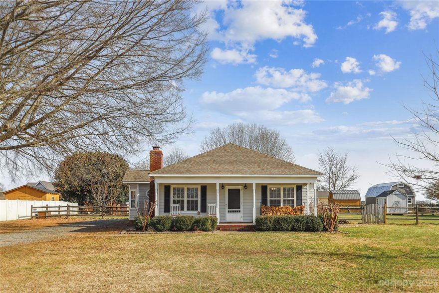 Southern charm at its best! This updated home on a 1/2 acre lot has EVERYTHING your heart desires. After enjoying the full front porch, enter this home which showcases a floor-to-ceiling brick fireplace (with a beautiful reclaimed wood mantle) and wide plank vinyl floors (2019). The home has many great upgrades including a new HVAC (2022), exterior painting (2023), tile backsplash, stainless steel appliances, beautiful countertops, ceramic tile, and a GINORMOUS fenced yard complete with a shed and firepit. Natural light shines throughout this lovely home. This well-maintained home is close to Waxhaw, Weddington, Indian Trail, Matthews, Wingate, and Monroe. The surrounding area is growing exponentially - this is your chance to live in the heart of an expanding community on a quiet cul-de-sac. The front yard features a gorgeous oak tree. Sun Valley schools.