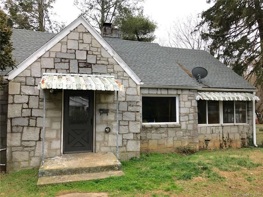 An original Oakley Stone Cottage with large unfinished basement and upper level bonus rooms that needs a little work to raise the square footage dramatically.  This home has all the appeal of a classic West Asheville address for half the money.  Large quarter acre lot with long range views.  Property could use fresh landscaping, paint, and updates, but with a little care it will become the home you dreamed of.... Huge basement with single car garage door. Perfect for workshop or studio.