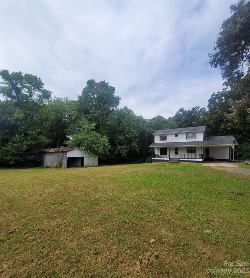 Great Country Home sitting Off the Road on 2+ acres & Surrounded by Mature Trees w/a Full Covered Front Porch that will Welcome you home.The Private setting will definitely be one of your favorite things about this home while out on the Large Back Deck having cookouts & entertaining under the New Canopy.Walking inside the home you will see the oversized gathering family room w/a freestanding fireplace, Separate Dining Room, Laundry Room w/Storage & Kitchen is equipped w/all appliances. Large Primary Bedrm & Bath & the additional 2 bedrms w/full bath are split plan. Per Seller Roof Approx.9 yrs,Lower Heat Pump in 2022 & Upper Heat Pump Approx.4 yrs,New Well Pressure Tank. Most Interior Walls & Trim are Freshly Painted & Seller to put in New Gravel Driveway.The huge barn/building does need work but is great for storage of your outdoor items. Home & Outbuilding are being sold As Is. If Privacy & Room to Roam is what you're looking for-This Home Is For You!