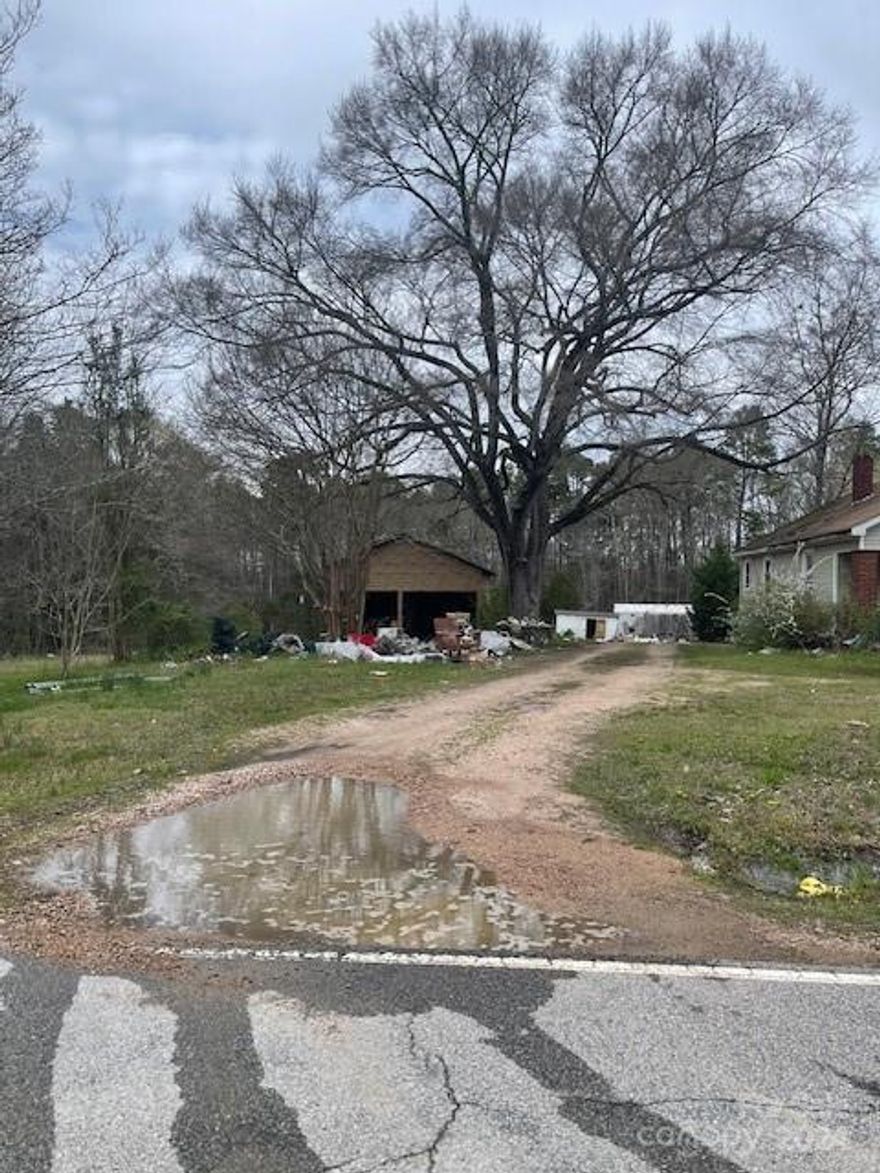 6.62 acres with a 2 BD 1 BA home.  Single wide mobile home and 2 buildings being sold at no value. Debris scattered throughout property. Property is in an estate and must be court approved. DO NOT attempt to walk property without a buyer agent present.
