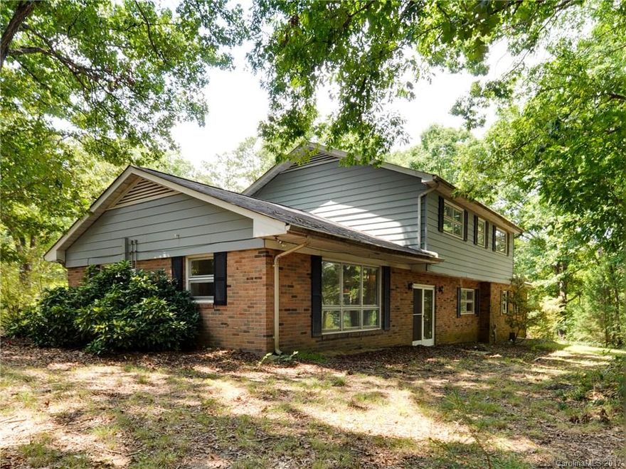 Excellent opportunity for investor or buyer looking for a renovation in a desirable location on 1.5 acres! Spacious floorplan throughout w/ oversized bedrooms & closets. Carpet removed on the entire 2nd level exposing beautiful original hardwoods! Home sits back from the road for extra privacy, rear yard is wooded w/ views of neighboring pond. Garage transformed into living space w/ bath & separate entrance perfect for workshop, or home office.  Home is sold AS-IS, no repairs made by sellers.