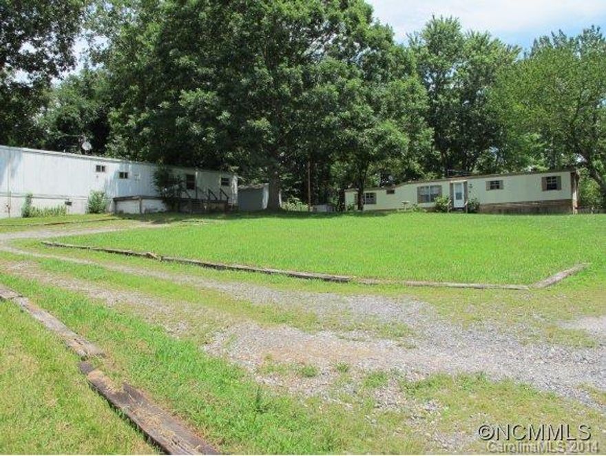 87 acre of level land with two older singlewide mobile homes. Public water & sewer. Mobile homes are rentals ($325 & $275 per month) but are not in great shape. Highest & best use of land is development. R-2 zoning allows modular and single family homes; up to 12 units per acre; minimum 6,000 square foot lots with public water/sewer; setbacks 20' front, 20' rear' 10' side.