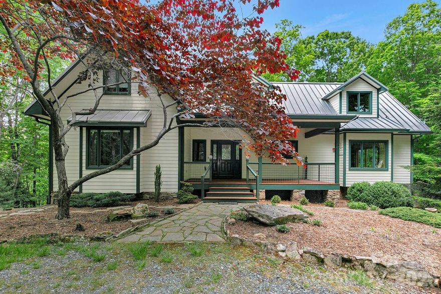 CHECK OUT THE VIDEO -- Welcome to 40 Walnut Ridge Circle, a custom-built mountain retreat offering 3 bedrooms and 3 baths on nearly 5 acres of private, wooded land at the top of Walnut Ridge in the sought-after Eagle Lake community. This exceptional home combines quality craftsmanship, natural beauty, and thoughtful design in a peaceful, elevated setting.

Step inside to a stunning great room with cathedral ceilings and floor-to-ceiling windows, filling the space with natural light and showcasing the surrounding landscape. A stone fireplace creates a warm focal point, perfect for cozy evenings. The home features Australian cypress flooring, custom cherry cabinetry in the kitchen and primary suite, and maple cabinetry throughout the rest of the home, highlighting the attention to detail and high-end finishes.

The layout is designed with privacy in mind, offering comfortable separation for guests and family. The upper level includes a spacious family room along with a bonus office/den or additional guest space, providing flexibility for a variety of needs.

The lower level is a true standout, featuring a woodworker’s dream workshop—fully outfitted and available for purchase with tools and equipment—along with a separate garage for additional storage or workspace.

Located within the Eagle Lake community, residents enjoy access to a 32-acre private lake, ideal for swimming, fishing, boating and beach access, all while being just minutes from downtown Brevard, DuPont State Forest, Pisgah National Forest, and a short drive to the Asheville Regional Airport.

With its combination of privacy, craftsmanship, and access to both nature and community amenities, 40 Walnut Ridge Circle offers a rare opportunity to experience the best of mountain living.