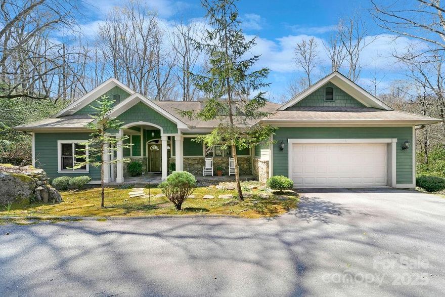 Tucked away on a quiet cul-de-sac, this charming Greg Bright-built retreat offers a seamless transition into your next chapter. Ideal as a low-maintenance second home or perfect retirement haven, it features a flat, circular drive and a level one-acre lot—rare in the mountains. Just minutes from the East Fork Gate, the home welcomes you with a slate-tiled front porch and double-door entry. Inside: vaulted ceilings with clerestory windows, rich natural wood trim, warm wood floors, and a split-plan layout with easy one-level living. The spacious primary suite includes serene views and a light-filled en-suite bath. Jeld-Wen windows frame the forest, where deer, turkey, and the occasional fox visit. Enjoy fresh mountain air and southern exposure from the screened-in back porch. Gas fireplace, stone walls from on-site boulders, and hardscaping add function and charm. Close to the lake, clubhouse, golf, dining, and pickleball.Buyer to pay a $13,500 or $15,500 one-time amenity fee at closing.