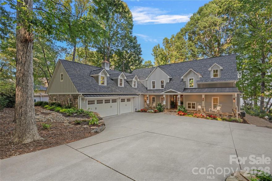 A one-of-a-kind waterfront estate on Lake Norman, fully transformed through a renovation completed in 2025 and ideally located just outside Cornelius in one of the lake’s best-kept secret neighborhoods. Perfectly positioned on a one-acre, tree-filled lot with resort-style amenities, this home combines timeless elegance with modern luxury. Walls of glass and expansive sliding doors frame sweeping big water views and breathtaking sunrises, while rare deep water at the double-slip dock allows for swimming and diving right from your backyard.

The thoughtfully designed interior balances warmth and sophistication, anchored by a soaring two-story natural stone fireplace, wide-plank Caribbean floors, and designer finishes throughout. A first-floor primary suite offers a private balcony with panoramic views, spa-inspired bath with heated marble floors, custom shower, and a spacious walk-in closet/changing room. The chef’s kitchen features an expansive island, Sub-Zero refrigerator, scullery with custom pantry, and adjacent lounge with wine fridge. A lake-level retreat includes a second kitchen, bourbon room, game room, and direct walk-out to a flagstone terrace with stone fireplace. Enjoy year-round living from the serene screened porch with hurricane shutters, or stroll past the koi pond and waterfall stream to your private dock with covered entertaining area, a high-powered boat lift, floating dock, and jet ski dock.

The grounds are truly a rare offering on Lake Norman - professionally designed with both beauty and livability in mind. Lush, layered landscaping blends mature trees, manicured lawns, and thoughtfully placed stonework to create both beauty and privacy. Expansive, usable yard space is a rarity on the lake, offering room to entertain, relax, or simply take in the water views from multiple vantage points. From the winding paths and tranquil water features to the seamless connection between indoor and outdoor living, every element of the landscape was intentionally designed to elevate the experience of lakefront living.

Every detail has been updated - hardboard siding, new roof, windows, HVAC systems, exterior stonework, custom lighting, irrigation, and professionally designed landscaping. The neighborhood enhances the lifestyle with a private beach, boat launch, pool, tennis/pickleball court and basketball court. Ideally located just minutes to shops, dining, and top schools, and less than 20 minutes to Uptown Charlotte and Charlotte Douglas International Airport, this estate offers an unrivaled blend of luxury, privacy, and convenience.  This is more than a home - it’s a lifestyle.