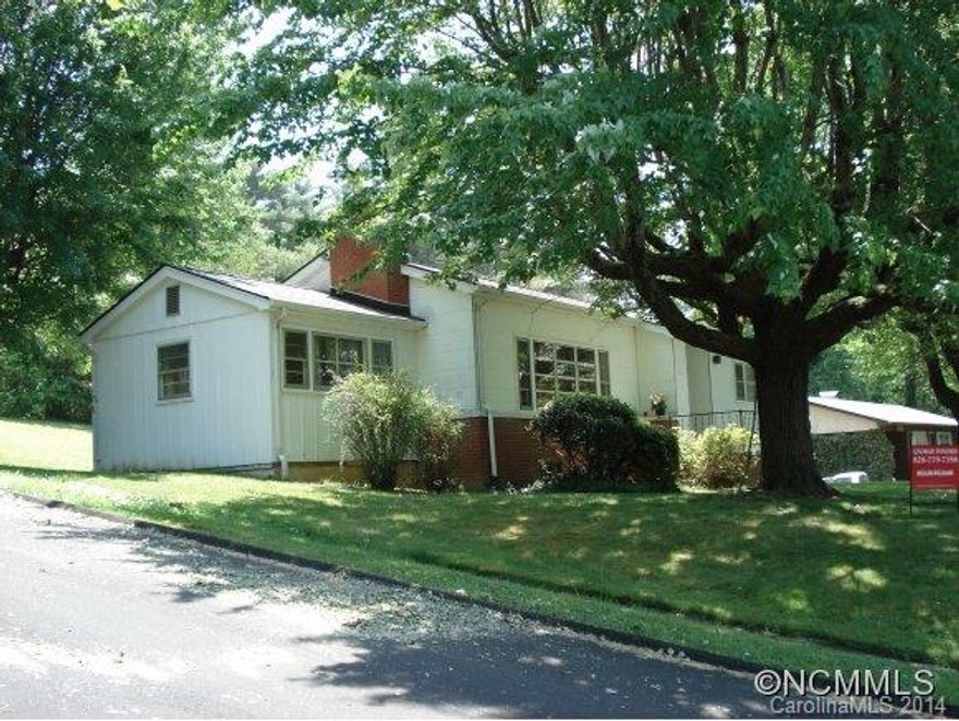 One block off Main St. in Weaverville! Walk to downtown, stores, and restaurants. 3 bedroom, one bath. Rare wood ceiling tiles, wood floors, lots of light and great wood burning fireplace with insert. Large screened in back porch overlooks private backyard w/ garden area. Corner double lot assures privacy or divide for two lots. Partial bath and workshop in basement. Home inspection available upon request from a qualified buyer.