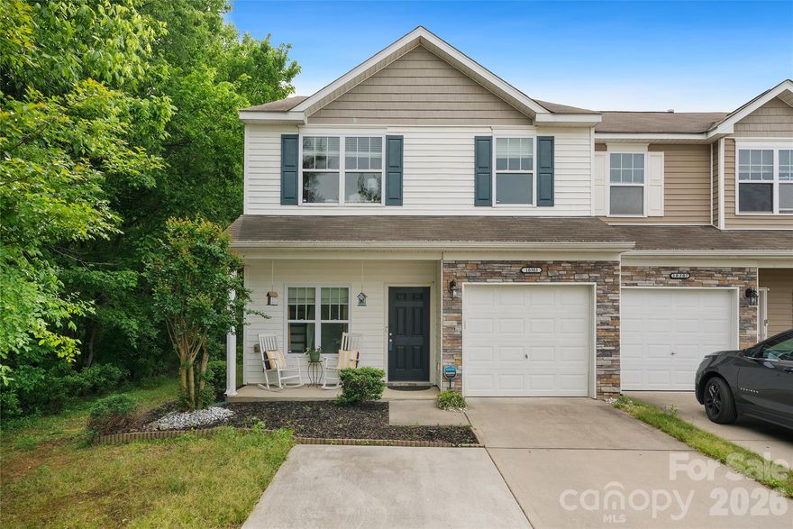 Beautiful end-unit townhome offering 3 bedrooms and 2.5 baths with a 1 car garage AND EXTRA PARKING SPOT in an established community with mature landscaping! A charming covered front porch welcomes you into a spacious entry foyer that opens to an airy, open-concept main living area. The inviting living room features a cozy gas fireplace and flows seamlessly into the kitchen and dining space — perfect for everyday living and entertaining. This home features no carpet — all LVP flooring installed last year and freshly painted throughout, giving it a crisp, updated, truly move-in ready feel. The kitchen shines with granite countertops, tile backsplash, stainless steel appliances, and ample cabinetry. The dining area includes sliding glass doors that lead to a private patio overlooking a peaceful wooded backdrop — ideal for relaxing or hosting guests. As an end unit, you’ll enjoy extra windows and abundant natural light throughout. Upstairs offers three bedrooms plus a versatile loft space. The spacious primary suite includes an en'suite bath and walk-in closet. Two additional bedrooms, a full bath, and convenient upstairs laundry complete the second floor. 
Community amenities include an outdoor pool and a green space with pet stations. Enjoy simplified living with an HOA that includes a green space with pet station, pool access, exterior maintenance, lawn maintenance and water - reducing upkeep, covering a key utility and giving you more time to enjoy your daily living. 
Conveniently located near UNCC, I-485, I-85, and just off Hwy 49 for an easy commute to Uptown Charlotte. Only 10 min from the UNC Charlotte Main Lynx Light rail Station. https://www.charlottenc.gov/CATS/Ride/Rail/Stations-and-Park-and-Rides/UNC-Charlotte-Main-Station. Move-in ready and waiting for you!