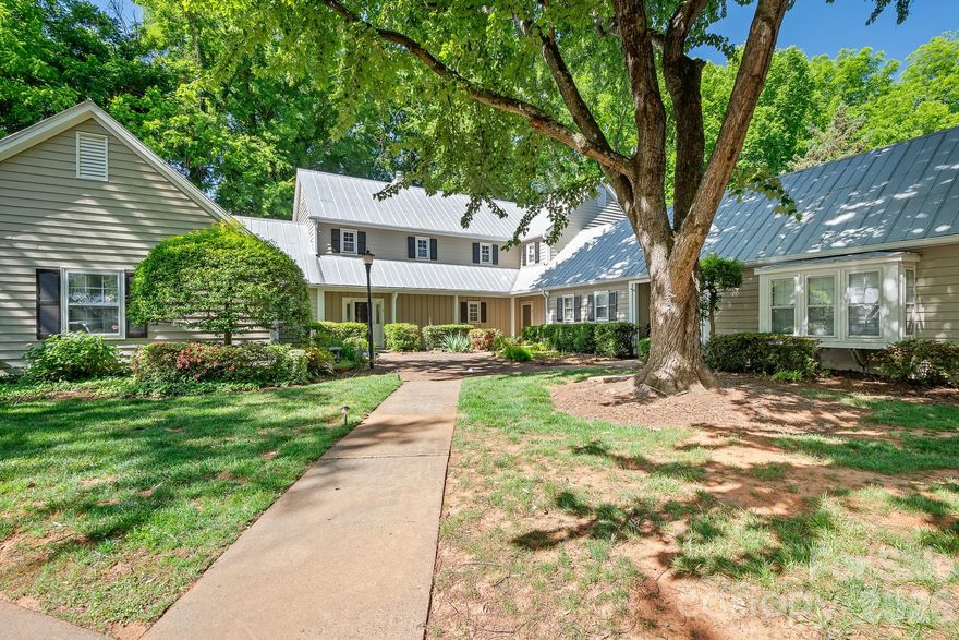 Enjoy the perfect blend of privacy and prime location in a picturesque neighborhood filled with tree-lined streets and a welcoming community pool. This delightful cottage-style condo features a secluded patio surrounded by a privacy fence, offering your own outdoor retreat. Nestled in the heart of Sedgefield, you are just moments from South End, Park Road, and Dilworth, with coffee shops, restaurants, and parks all within easy reach. Step inside to discover a living room brimming with character, complete with a cozy fireplace and elegant French doors that open to the backyard patio and fresh paint throughout. The open kitchen flows seamlessly into the dining area, with space for a breakfast bar and direct access to the patio through another set of French doors. An updated half bath graces the main level. Upstairs, unwind in the primary bedroom, where charming doors overlook the patio, and indulge in the newly renovated primary bath with a new luxurious shower, vanity, sink, & mirrors. The conveniently located hallway washer and dryer serve both bedrooms. The second bedroom offers its own en-suite bathroom, updated vanity, sink and mirror and a walk-in closet, with more charming doors framing views of the patio. The patio also has an outside storage area. Enjoy the treelined walk to the neighborhood pool.  The delightful, charming condo won't last long, it's just waiting for you to enjoy.