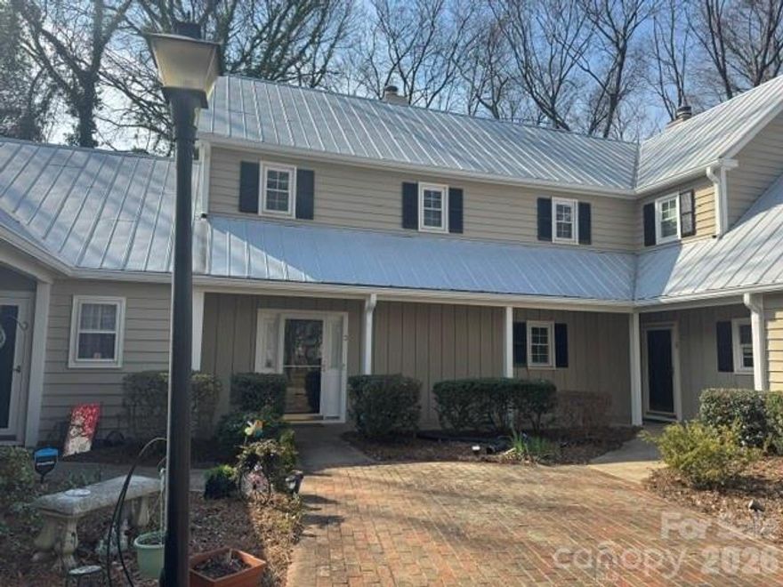 Enjoy the perfect blend of privacy and prime location in a picturesque neighborhood filled with tree-lined streets and a welcoming community pool. This delightful cottage-style condo features a secluded patio surrounded by a privacy fence, offering your own outdoor retreat. Nestled in the heart of Sedgefield, you are just moments from South End, Park Road, and Dilworth, with coffee shops, restaurants, and parks all within easy reach. Step inside to discover a living room brimming with character, complete with a cozy fireplace and elegant French doors that open to the backyard patio and fresh paint throughout. The open kitchen flows seamlessly into the dining area, with space for a breakfast bar and direct access to the patio through another set of French doors. An updated half bath graces the main level. Upstairs, unwind in the primary bedroom, where charming doors overlook the patio, and indulge in the newly renovated primary bath with a new luxurious shower, vanity, sink, & mirrors. The conveniently located hallway washer and dryer serve both bedrooms. The second bedroom offers its own en-suite bathroom, updated vanity, sink and mirror and a walk-in closet, with more charming doors framing views of the patio. The patio also has an outside storage area. Enjoy the treelined walk to the neighborhood pool.  The delightful, charming condo won't last long, it's just waiting for you to enjoy.