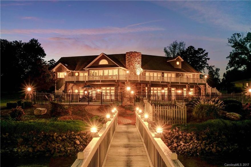 Beautiful, one of a kind, waterfront home with an outstanding view of Lake Norman!  Home has an open floor plan with vaulted ceilings and new wood flooring on both levels.  Owner's suite is on main level with access to the large wrap around deck.  The basement has a full kitchen to include granite, stainless steel, and stunning cabinetry. Enjoy the spacious, manicured yard with full irrigation and a large pool that overlooks the lake.