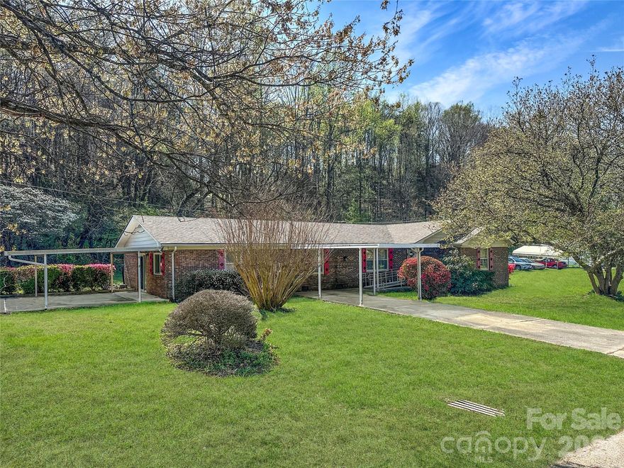 Charming Brick Home with Workshop & Convenient Location – Marion, NC - This well-maintained 3-bedroom, 2-bath brick home offers comfort, character, and incredible convenience. Perfect for anyone seeking a spacious, move-in-ready residence with room to work or play.  Journey inside to a formal living room that sets a welcoming tone. The heart of the home features a cozy den adjacent to the kitchen, complete with a wood-burning fireplace—ideal for relaxing evenings or entertaining guests. A second den, located just off the carport, provides versatile space that would make an excellent home office, hobby room, or even a private home gym. The primary suite offers its own private bathroom for added convenience and privacy. Two additional bedrooms and a full bath complete the thoughtful layout. Recent mechanical upgrades give you peace of mind, including a brand-new heat pump and a brand-new roof. The new owner can just add their own finishing decorative touches! Outside, you’ll appreciate the double carport for easy parking and the very large detached workshop—perfect for storage, projects, hobbies, or even a potential studio or small business space. The level yard provides plenty of room to enjoy the outdoors. Located just minutes from downtown Marion and with quick access to Interstate I-40, this home makes commuting to Asheville a breeze while keeping you close to local shops, dining, and amenities. Don’t miss this rare combination of classic brick construction, modern updates, flexible living spaces, and a prime location!