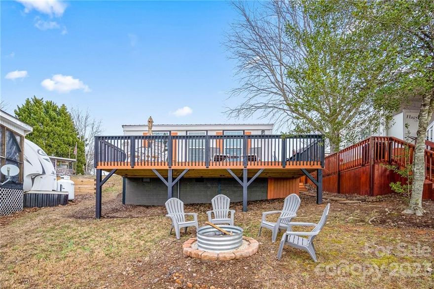 Come enjoy the lake view from this remodeled camper with stick-built room addition (built 2021) on a deeded lot inside the gated waterfront community of Badin Shores Resort at Badin Lake.  A new roof was installed on the camper in 2021, new deck in 2021, heating/air just months ago, all new full bath with tub/shower combination, new 1/2 bath, new kitchen with modern electric smooth surface stove, large deep sink, butcher block counter tops, & room for 6 to dine!  The camper features (bedroom #1) two twin beds with new memory foam mattresses & Beddy's bedding, the room addition features a bedroom with queen custom headboard & Beddy's bedding also...wake up & enjoy the lake view out your bedroom window.  A spacious deck & yard offer plenty of room for entertaining  your guest around the firepit or while enjoying a game of cornhole.  This beautiful property comes with all interior furnishings & decor. Come enjoy Badin Shores Resort & all the fantastic amenities the resort offers.