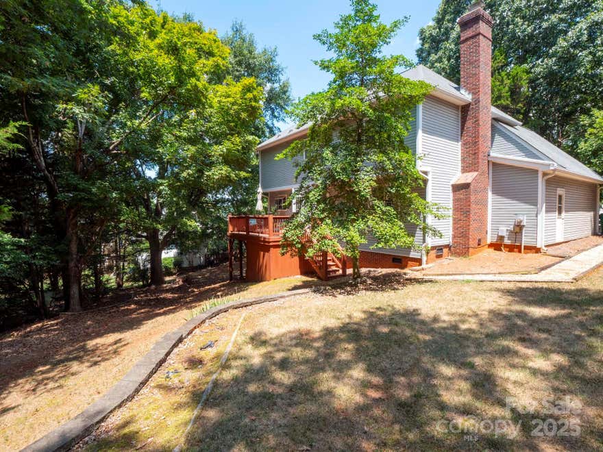 Nestled in one of the most sought-after areas of growing Charlotte, Steele Creek, this 2-story, 4 bed 2.5 bath home sets on a wooded lot next to the community boat slips. Boat slip #9 conveys with the property. This is a value that most don't appreciate. Price around the area marinas and you will understand the value of having this unique feature. Well maintained with HVAC replaced in 2021 (downstairs) and roof 2010 (with modifications/repairs in 2025.) Deck redone in 2023. Kitchen reno 2023. New toilets 2022. Newer kitchen appliances. This home flows with a main level sitting room, family room, half bath, laundry and back deck. Upstairs features 4 bedrooms with generous closets as well as an unfinished bonus room that is perfect for storage or an opportunity to finish for extra square footage. Perfect opportunity for someone wanting an investment property or fix up to have the potential for lots of equity! Deeded boat slip comes with this gem of a property in the heart of it all! Investors welcome!