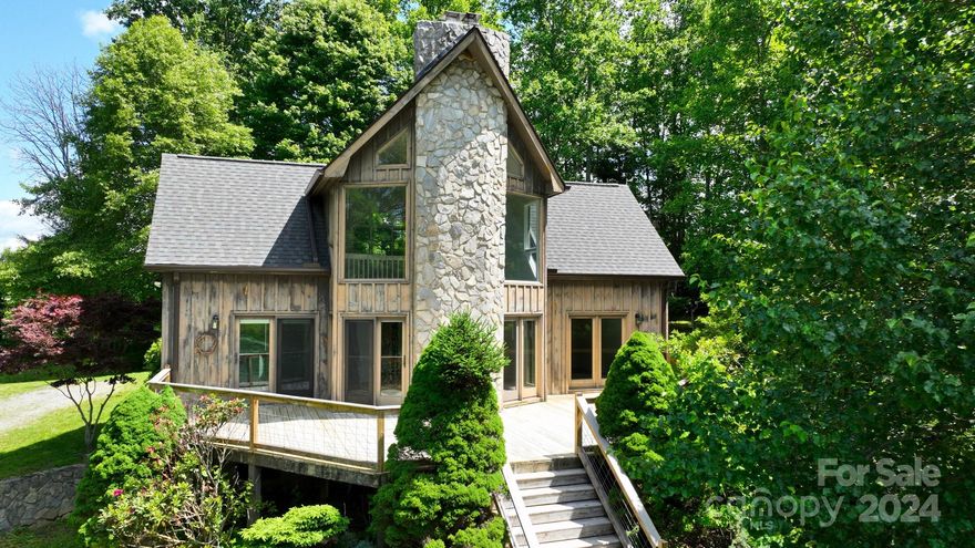 Escape the ordinary and embrace the serenity of mountain living in this 2-bed, 2-bath home nestled on ~1.32 acres in picturesque Piney Creek, NC. Perfect for year-round living or weekend getaways, the home boasts a versatile floorplan with a loft, a bonus room, and ample storage in the basement. Ready for Expansion? Enjoy the peace of mind of a 3-bedroom septic permit already in place for future possibilities. This home offers many improvements (see list). The wood-burning fireplace offers cozy nights, and a gas line can be installed for gas logs. Relax by the firepit, unwind in your hammock, or cultivate your green thumb in a spot perfect for a garden – all while enjoying the mesmerizing views. Located ~5 minutes from the historic New River, you'll enjoy year-round access to outdoor activities. Spacious windows create a seamless connection to the surrounding beauty, inviting the outdoors in.