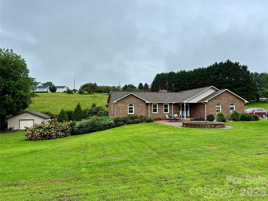 Brick ranch with full basement on a large fenced 0.89-acre lot, conveniently located near downtown Morganton, I-40, and Lake James. Step inside to a welcoming living room with a brick fireplace with gas logs, flanked by built-in shelving, and an abundance of windows that fill the home with natural light. The kitchen is centrally located and opens to a spacious dining room, making it ideal for entertaining. Enjoy the newly added enclosed sunroom with heat and air, plus a small deck perfect for grilling or relaxing while overlooking the large backyard and mature landscaping.

This split-bedroom floor plan features a main-level primary suite with an updated bath and large walk-in closet, along with two additional bedrooms and a hall bath. A spacious two-car garage is also located on the main level.

The full basement offers a family room, full bathroom, two additional rooms ideal for a rec room or office, plus a utility/storage room. The entire property is fenced and includes an electronic gate for added privacy. Additional highlights include hardwood flooring, vaulted ceilings, and a brick fireplace with gas logs. An additional storage garage with a gated driveway adds even more functionality.

With no restrictions, this property provides the flexibility to operate a home-based business.

Don’t miss this opportunity to enjoy both convenience and privacy.
