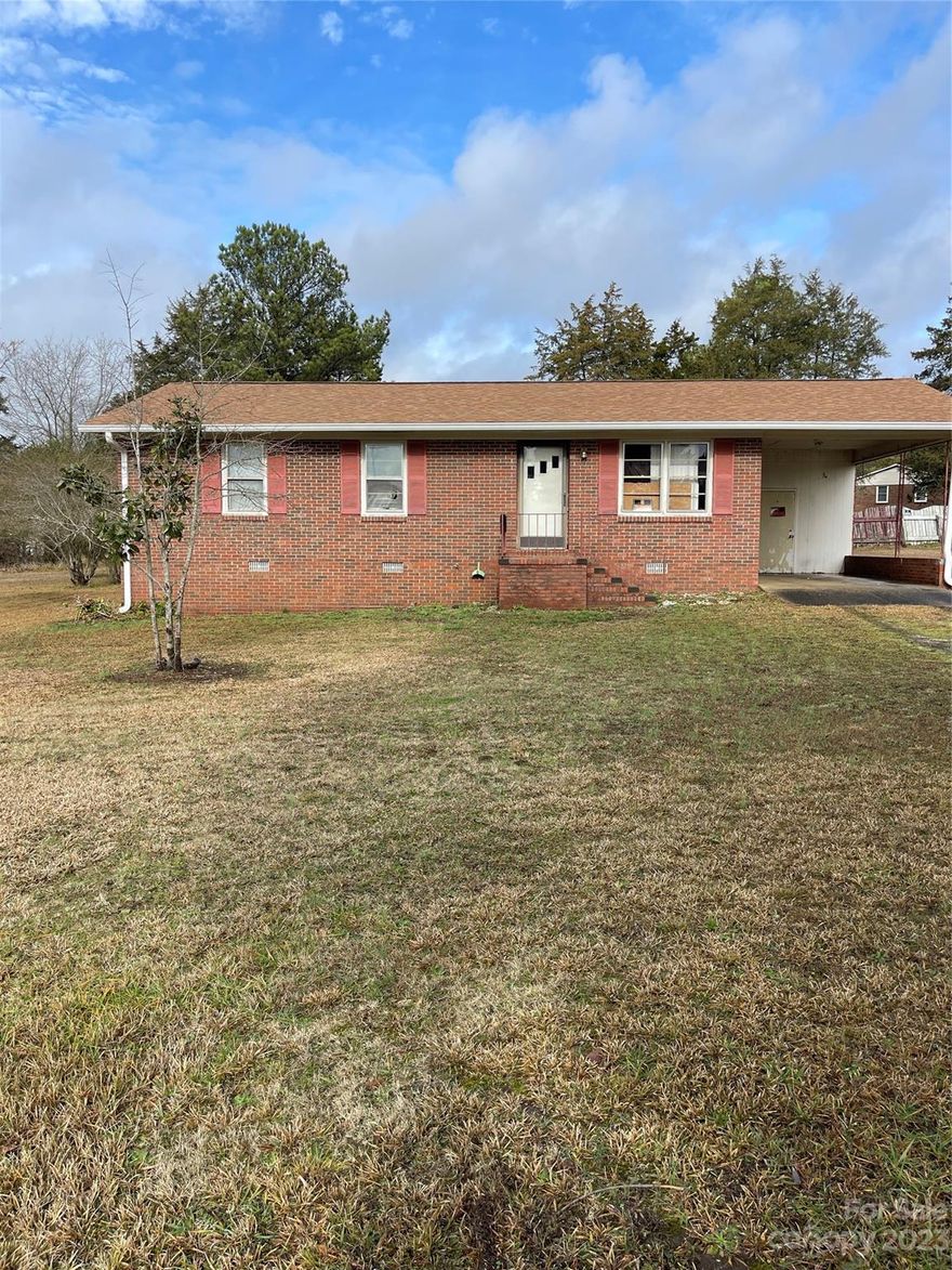 Cozy 1025 Sq ft brick ranch with one-car carport on a .32-acre lot.  This property offers potential for customization and is situated in a convenient location. The generous lot size provides potential for outdoor enjoyment. Home being sold "AS IS."