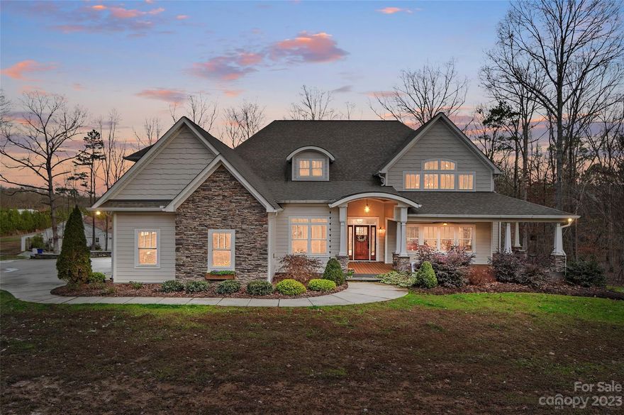 Escape the hustle & bustle as you make this house on almost 12 acres your home – a retreat that offers both the comforts of living & the joy of endless possibilities. The wrap around front porch has plenty of room for your rocking chairs. Natural light floods the living room with 20' high ceiling & a wall of windows. The heart of the home is a well-appointed kitchen, ideal for whipping up your favorite meals. Picture yourself enjoying morning coffee on the private porch off the primary bedroom or taking in the scenic views of your expansive property from the covered rear porch. Featuring three bedrooms, plus office on the main floor with large bonus room with a wet bar upstairs,  this floor plan is has it all!. But there's more to this property than just a charming home. For the handy individuals, a spacious workshop awaits, ready to accommodate your creative endeavors or practical projects. Easy commute to Charlotte, with many dining & shopping options nearby in the town of Locust!