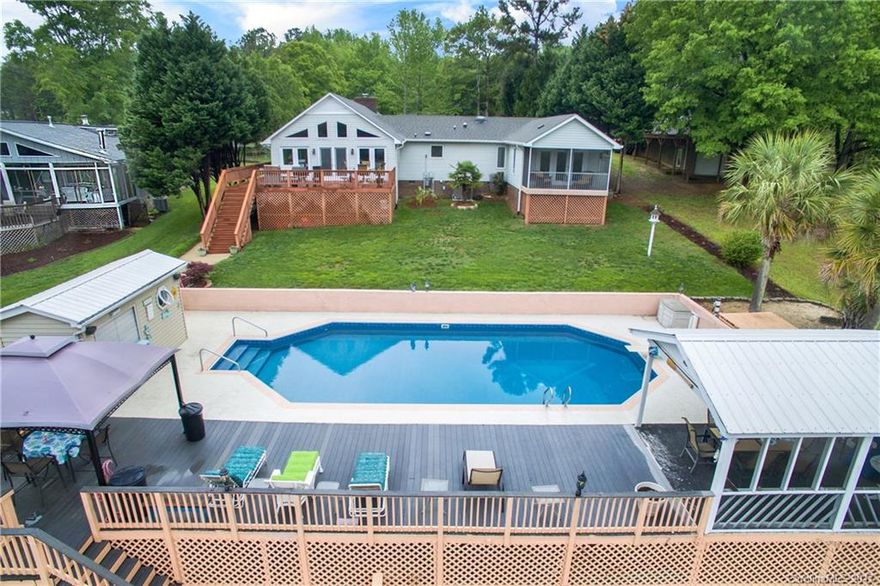 Updates and so much more. This LAKE FRONT home has it all! Master has large sitting room, TODAY kitchen includes granite, skylights, Pergo, Pella Windows. Possible 4th bedroom or office/nursery/or... In ground salt water pool with 1 yr old pool liner, bath at the pool, irrigation, dock, oversized attached 2-car garage. 1 Year America's Preferred Home Warranty. 2 rose bushes and a small tree marked with confetti tape will not stay.