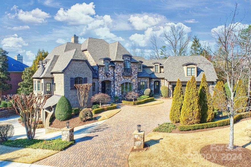 Nestled within the prestigious confines of Ballantyne Country Club, where luxury meets leisure, stands a masterpiece of timeless design. Welcome to 14720 Rudolph Dadey Drive, a custom-built sanctuary crafted by Arcadia Homes in 2008,and designed by the renowned architect, Frank Snodgrass. Situated on arguably the most coveted street in BCC, this home has three levels & offers over 7,200 square feet of living space. With five bedrooms and seven baths, including a main level master suite retreat, this home has it all. A charming veranda and a spacious covered patio beckons with the tranquil sounds of the waterfall feature is ideal for leisurely outdoor dining & grilling. A fully equipped basement boasting a spacious media room, billiards area, bar and exercise room, ensuring endless hours of amusement for family and friends alike. In essence, 14720 Rudolph Dadey Drive is more than just a home; it's a legacy of luxury waiting to be experienced and cherished for generations to come.