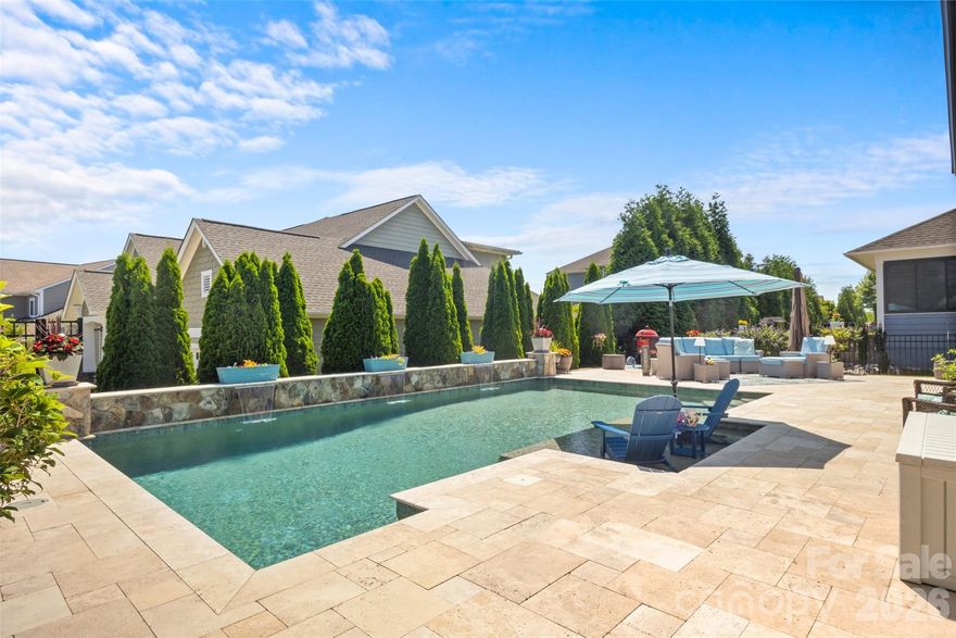 Step into luxury living with this exceptional home designed with two main floor en-suites. The backyard is truly an oasis, featuring an in-ground heated pool complete with a Baja-shelf perfect for easy wading, sunbathing, or relaxing with friends.  A spacious travertine patio surrounds the pool, along with a covered dining area ideal for outdoor meals and year-round enjoyment, all framed by a beautiful landscaped fenced yard.  Inside, the home offers an impressive layout with two main-floor en-suites, including a stunning primary retreat with a spa-like bathroom and an expansive custom closet system.  The second en-suite provides its own dedicated full bath, making it perfect for guests or multigenerational living. At the heart of the home is a dream kitchen built for entertaining, showcasing an extra-large island, gas-burning stove top, drop zone, and abundant cabinetry. The kitchen flows seamlessly into the dining area and sun-filled great room where plentiful natural light and backyard views create a warm, welcoming atmosphere.  A convenient half bath, along with a private office completes the first floor. Upstairs, you'll find two additional bedrooms, a full bathroom, and a large flex space ideal for a media room, game room, or additional office.  Every detail of this home has been thoughtfully designed to offer elegance, functionality, and resort-style living.  Nearby, enjoy Massey's amenities, including a lazy river, Olympic-sized pool, water slide, splash zone, and a community clubhouse with gym and media room.  This home has an unbeatable location close to Schools, Costco, Target, plenty of grocery stores, restaurants, MUSC Medical Center and plenty of shopping.