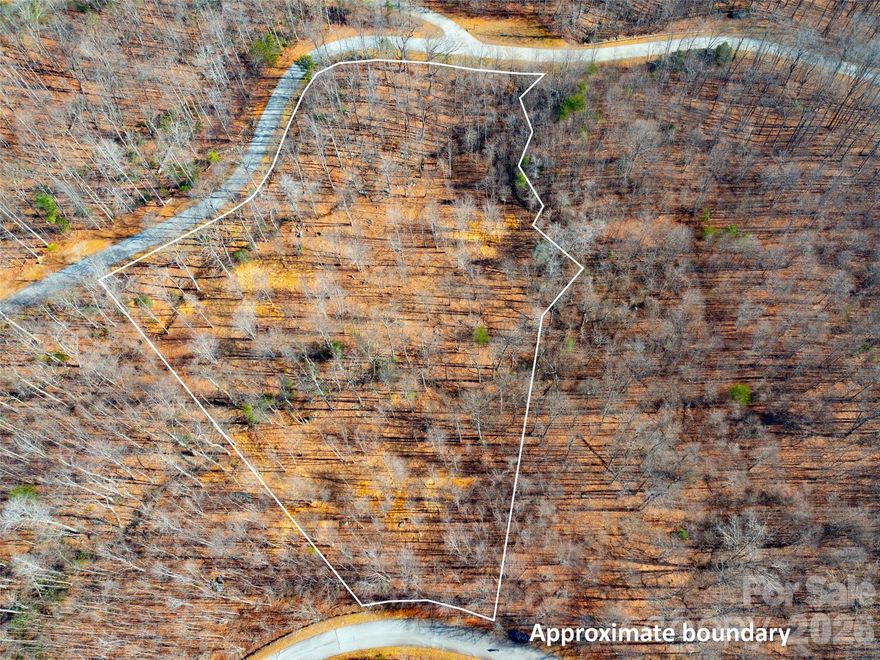 Large, recently cleared, gently rolling lot with multiple build sites to chose from. Beautiful development with paved roads, fiber optic, water, sewer, & natural gas. Community offers 24 hour staffed greeters cottage and many scenic walking trails including a waterfall trail. Brights Creek Club offers a 19 hole Tom Fazio championship golf course, tennis/pickleball, and mountain lodge with restaurant and bar. New Amenity area features an outdoor heated pool, two lane bowling alley, fitness center, casual dining, and many beautiful gathering spaces with a huge stone fireplace and full bar. Make an appointment to experience Bright's Creek today.