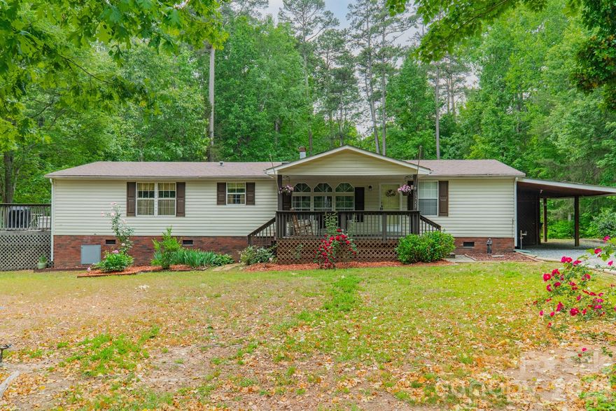 Welcome home to this warm and inviting 3-bedroom, 2-bath doublewide on nearly an acre in the established Island Creek community of Stanfield. With over 1,680 square feet of thoughtfully designed living space, this home offers an open floorplan, split bedroom plan, vaulted ceilings, kitchen island, breakfast bar, garden tub, walk-in closet, and a wood-burning fireplace in the living room — everything you need to settle in and make it your own. Step outside and the property truly shines. Enjoy summer days in the above-ground pool, relax on the covered front porch or deck, and take advantage of the outbuilding and shed for hobbies, storage, or a workshop. The lot is level, cleared, and bordered by trees for natural privacy. Architectural shingle roof, heat pump, central air, and a paved road at your front door. No HOA. No city taxes. Flood Zone X — no flood insurance required. Eligible for FHA and conventional financing. All of this just minutes from Locust, approximately 30 minutes to Concord, and under an hour to Charlotte — with Morrow Mountain State Park and Lake Tillery practically in your backyard. Country quiet, city close.