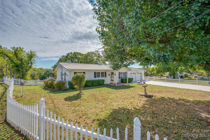 Well Maintained Home on 1.73 acres with a White Picket Fence! This updated property offers living room with a fireplace, kitchen with granite countertops, loads of cabinets, and stainless appliances, both large bedrooms have double closets, bathroom has tile shower with a seat and granite countertop, attached double garage, composite decking, HVAC new in 2022, a metal roof, and vinyl windows and siding. There is also a 14x21 building with a garage door.