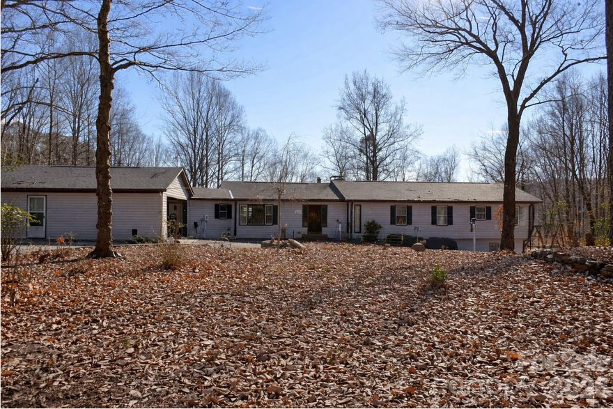 Welcome to this expansive Green Creek rambler set on 11.38 acres of privacy, views, and opportunity. The property includes both the main residence and a single wide home that can serve as a guest house, multigenerational space, or an income-producing option. Located off Jackson Grove Road and surrounded by beautiful equestrian properties, this setting offers 180 degree mountain vistas, access to Hooper Creek, a ridge top gazebo, and an RV hookup. The long gravel drive leads to an early 1980s ranch with 3 bedrooms, 2 full baths, 2 half baths, and a bright open great room. Enjoy the stacked rock fireplace or relax on the screened porch that overlooks the land.
The kitchen is the centerpiece of the home with a six burner Jenn Air cooktop, custom hood, oversized island, Bosch dishwasher, and double wall ovens. A spacious laundry, pantry, and sewing room connects to the attached two car garage which includes two separate storage areas. Down the hallway are three bedrooms, each with its own bath, along with a generous study with custom built ins. From the study, a spiral staircase leads to the finished basement that features a fireplace, large flex space, a hot tub room, and a mechanical and workroom with sink, as well as an additional half bath.
The property also includes a large detached barn or shop with room for more than three vehicles and a full upper storage loft. The roof on the main home is approximately five years old. This property offers a rare combination of acreage, privacy, versatility, and usable space in a sought after Polk County location.