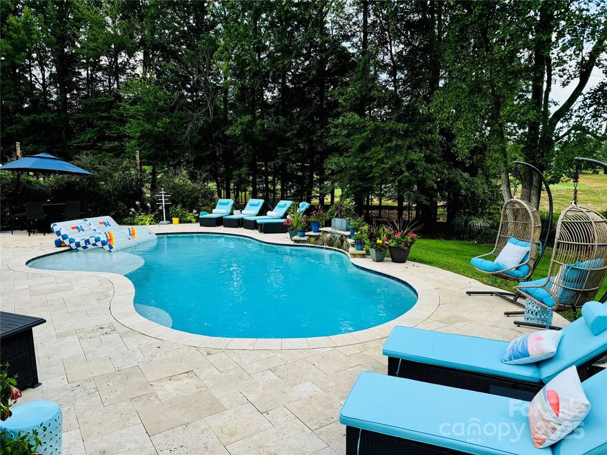 Overlooking the Peninsula Golf Course with a heated salt water pool, outdoor kitchen & screened patio this home is ready for entertaining. Fully renovated over the past few years, this spacious 5 bedroom home w/ office & large bonus sits in a great neighborhood w/ lake access, boat launch and beach. Large kitchen w/ pantry, farm sink, marble counters and Dacor appliances. Upstairs has all new carpet, new hall bath & new marble master bath with walk-in closet. Denon HEOS surround sound throughout. Guest suite on main level. Double staircase. Outside you will find a private backyard overlooking the golf course, 3 car garage w/ added concrete space extending the driveway. The built in outdoor kitchen sits on a travertine patio w/ a 42" Wolf grill w/ infrared burner & rotisserie, marble top & beverage fridge. The saltwater pool, built in 2018 has a new salt cell, variable speed pump & gas heater, all wifi. Whole home water filtration w/ reverse osmosis added in '21. Wifi irrigation.