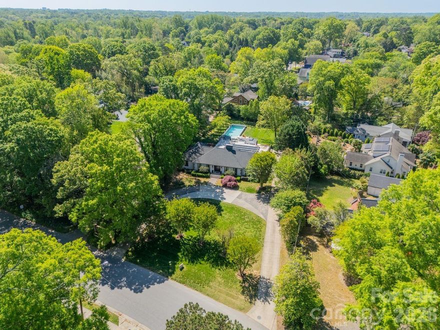 Located in the heart of Plaza Midwood, this exceptional full-brick residence was on 2025 Midwood Home Tour. It  offers over 3200 square feet of refined living space on a beautifully positioned 0.71 -acre lot. This ranch home features an open concept kitchen, expansive living and entertaining spaces, including a gracious dining area, elegant living areas and a fireplace. The primary suite provides convenience and privacy, complemented by a luxurious en-suite bath. California closet and private deck and fenced yard. You will also find you’ll find two spacious bedrooms, 1 full bath. The bonus room adds a flexible living space with a ½ bath that leads to an is equally impressive outdoor space with an in-ground salwater pool, irrigation system in backyard?, and a fenced backyard designed for relaxation and entertaining. The circular driveway and side-facing two-car carport provide both convenience and striking curb appeal. Easy entrance off the carport. This home delivers one level living, wonderful entertaining spaces,  location, and lifestyle in one of Charlotte’s most sought-after neighborhoods. Situated within close proximity to Uptown, Charlotte Country Club sits directly behind the property, Midwood Park is just steps away, and some of Charlotte's best dining, entertainment, and recreation options are right around the corner.