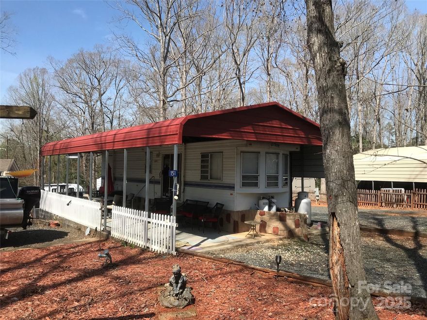 Level double lots on a corner! Talk about plenty of parking for everything, this lot has it. 22x40 concrete pad with metal carport. 1994 Terry camper 39' with 2 slides. 2 bedrooms, 1 bath, real potty and washer and dryer included. Underpinned, 10 gal elec water heater. New flooring with extra flooring under a bed. Most furnishings to remain (excluding items on porch). Fire pit, swing, storage building all included. Propane heat has never been hooked up. Current owners used plug in heaters. Microwave does not work. One fan on porch does not work.
2018 Sweetwater 18' pontoon with 60 HP 4 stroke motor available for an additional $16k.
All clients must be with a realtor to gain entrance to the community.