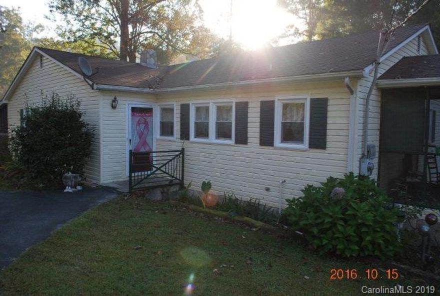 Pleasant Gardens area-3 bedroom, 2 bath vinyl & rock home on .84+/- acres.  This home offers hardwood floors, thermopane windows, solar panels, heat pump and gas fireplace.  In addition you have a full basement with a one car garage, wood stove and a recreation area.  A covered screen porch always you to enjoy a nicely landscaped yard with a small spring fed creek.  The home is convenient to Marion, I-40, Asheville, Lake James, WNC mountains and more.