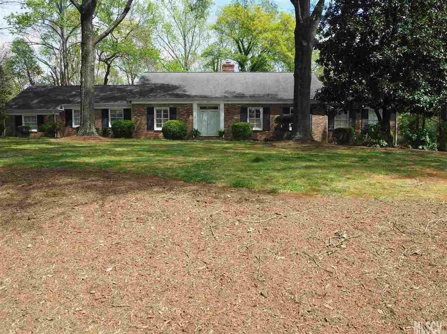 Straight out of Southern Living this sprawling brick ranch in desirable NW Hickory features three bedrooms, three full and one half bath, living room, great room, dining room, breakfast nook, laundry room and spacious screened porch. Downstairs is a den, the bedroom and third full bath. Luxury and serenity All rooms are generously sized. The kitchen with granite counter tops opens to the great room which has a beamed ceiling, fireplace, built-ins and sliding doors leading to the spacious screened porch. Three fireplaces. Heavy molding throughout main level. Main-level bedrooms have private full baths. This gracious home sits on private wooded 1.15 acre lot.