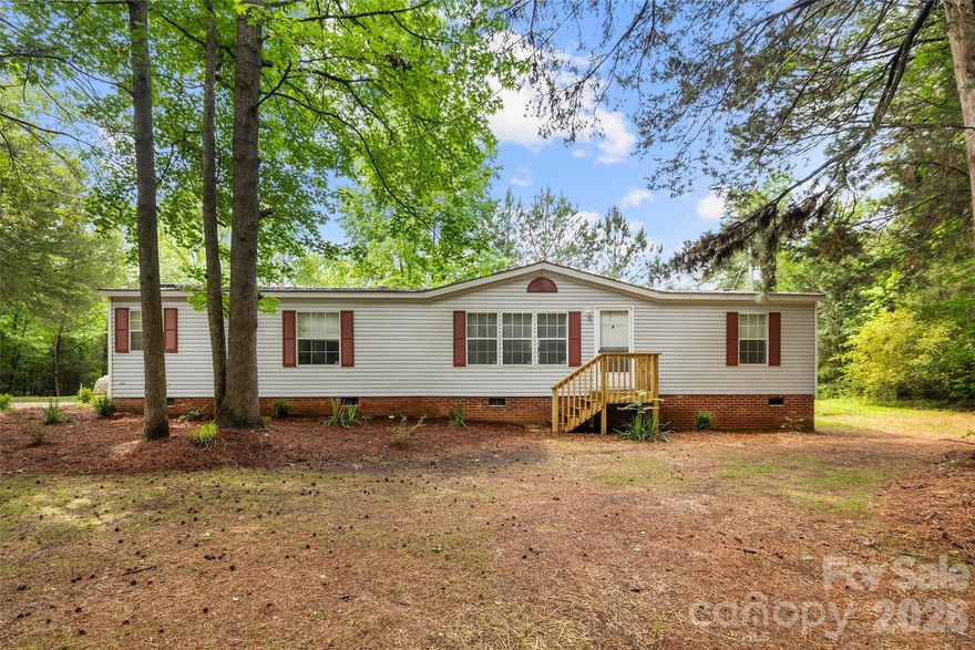 Welcome to this charming 3-bedroom, 2-bath well-maintained home. A long gravel driveway leads the way, winding through the trees, creating a private and peaceful setting for you to enjoy. This home offers comfortable living spaces and a versatile bonus room that is perfect for an office, study, craft room, or flex space. Surrounded by mature trees and at just under 2.5 acres, this property offers privacy and a serene natural backdrop while still being conveniently located near schools, shopping, Interstate 77 and everyday amenities.