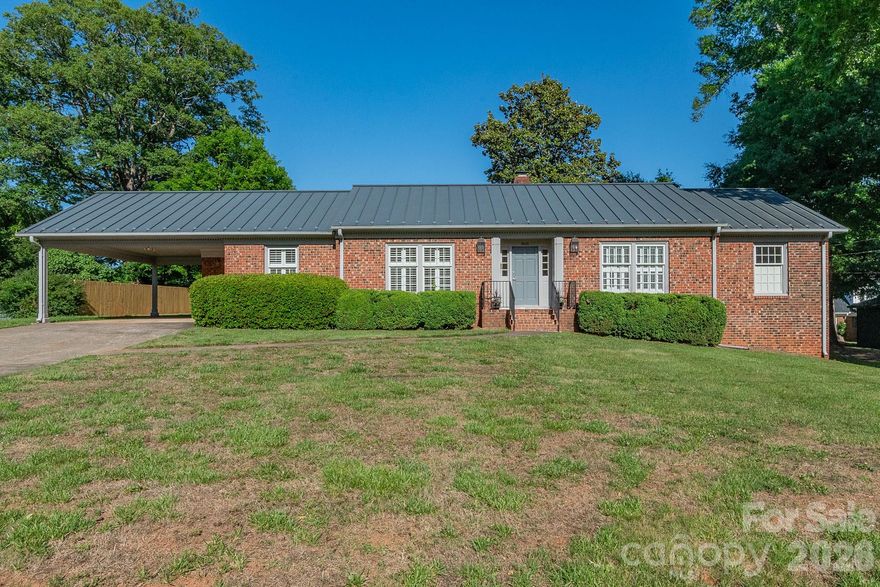 Beautifully maintained and full of charm, this home features a lifetime gable metal roof, hardwoods throughout, fresh paint, interior shutters, and stunning custom cabinetry in the kitchen, bathrooms, and mud room. The kitchen also offers a spacious pantry and a charming pocket door leading into the den, perfect for entertaining or cozy nights in.

As a true testament to the care poured into this home over the years, the custom front porch light fixtures were specially made in Charleston and have developed a timeless patina with age.

The primary suite features a custom closet organization system, while the basement provides incredible flex space ideal for hobbies, gardening projects, storage, or a workshop complete with a work table that will remain with the home. Outside, enjoy ample parking and yard space in a welcoming neighborhood loved by all.

Perfect for first-time home buyers, downsizers, or anyone looking for a wonderful opportunity. Don’t let this one pass you by!