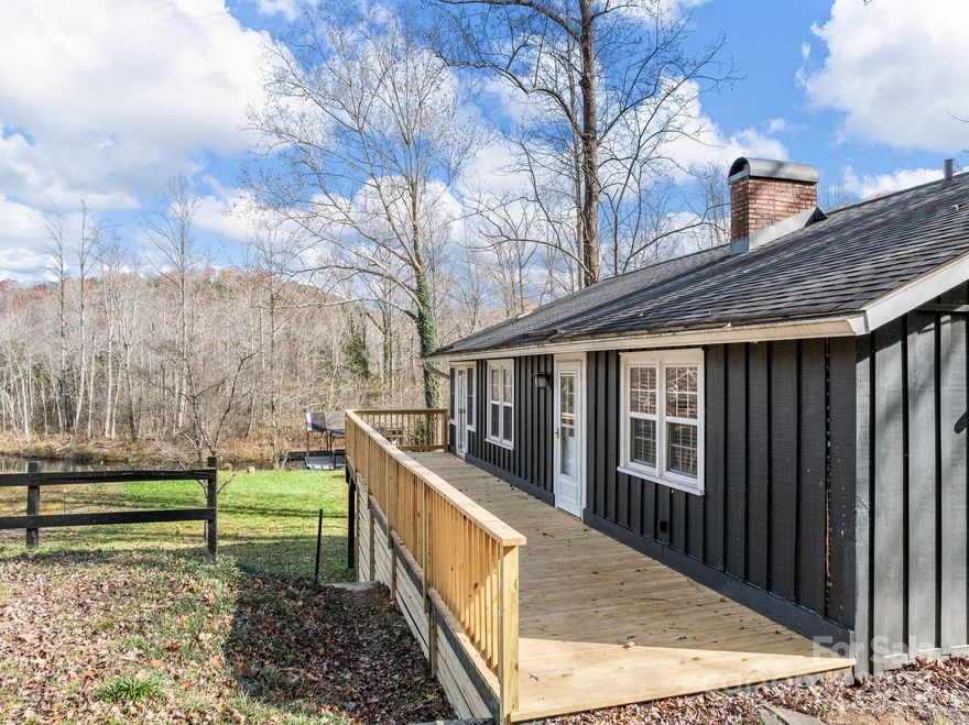 This storybook 2BR/1BA cottage sits tucked in a tranquil 3rd-basin cove, framed by enchanting mountain and water views. Inside, hardwood floors, a spacious kitchen, and a cozy fireplace create a warm, welcoming retreat. A large enclosed porch invites year-round relaxation, while the expansive deck feels like a front-row seat to lake life. The oversized unfinished basement is brimming with potential for a game room or effortless hangout space. Gentle water frontage makes launching kayaks, canoes, and paddleboards a breeze. Please note that the covered dock does not belong to this property. 
**Nestled in the foothills between Landrum, SC, and Tryon, NC, Lake Lanier is a private, serene mountain lake community — a true hidden gem. Set against the backdrop of rolling hills and woodlands, the area offers a peaceful, nature-centric lifestyle while still being just minutes from the charm of downtown Landrum and Tryon.**