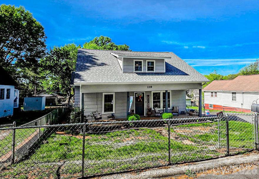 Discover your new sanctuary in the beautiful home!  Located on a corner lot close to town, this home is a short drive to restaurants, shopping and the Rails to Trails.  This is a rare find with the convenient location and 4 bedrooms.  This home lives large, has a warm feel with light colors and features a fenced-in front and back yard.  Enjoy the warm weather from the shade of the covered front porch.  This home is turn-key.  Schedule a tour today and embrace a lifestyle of comfort and convenience!